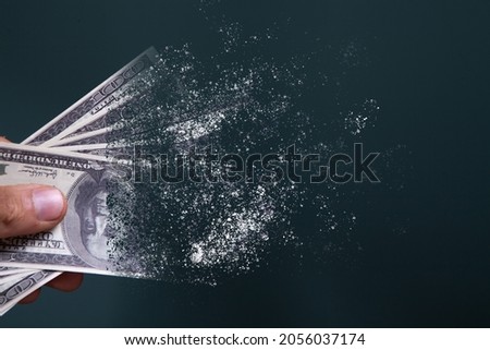 dollar bills disappear on a blue background