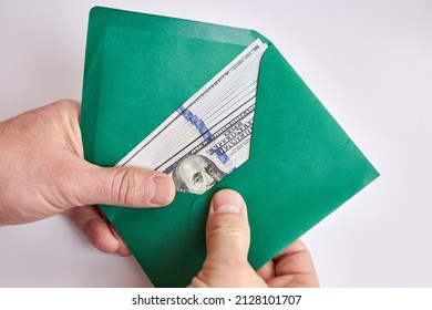 Dollar Bills In A Green Envelope. Bribe Offer.