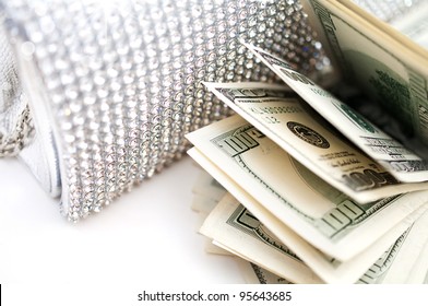 Dollar bills with luxury handbag