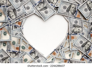Dollar bills in the shape of heart. The love of money. Valentine's day concept. Heart shape sign with 100 dollar banknotes. Valentine concept background. cash gift for a loved one. holiday 14 February