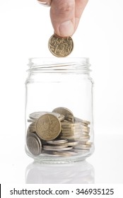 Dollar coin cash donation into glass jar