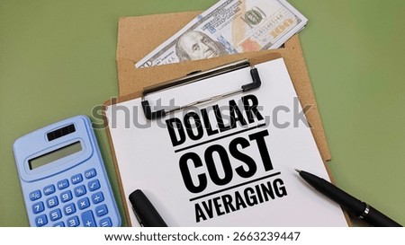 Dollar cost averaging (DCA) strategy written on clipboard with black pen, calculator, and US Dollar, representing disciplined investing and market risk control. 