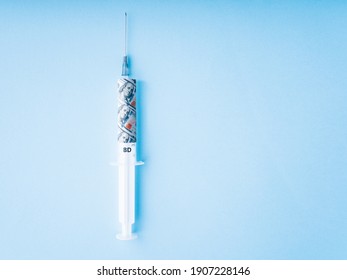 Dollar Injection: A Syringe With A Banknote Inside For A Recovery Economy. Vaccine Price Or Vaccine Cost Concept. Covid Vaccine Cost Symbol. Pharmacy Business Concept.