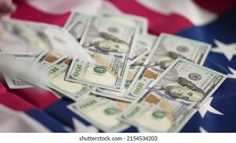 dollar money and American flag. bankrupt man counting money cash. business crisis finance dollar concept. close-up of a usd hand counting paper dollars. exchange finance economy dollar pay tax