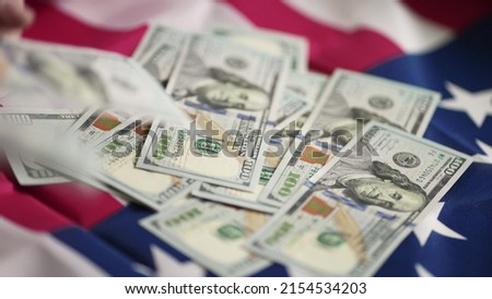 dollar money and American flag. bankrupt man counting money cash. business crisis finance dollar concept. close-up of a usd hand counting paper dollars. exchange finance economy dollar pay tax