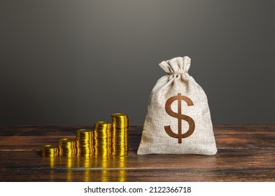 Dollar money bag and increasing stacks of coins. Savings and accumulation. Economic growth, GDP. Rise in profits, budget fees. Investments. Raise incomes, increase salaries. Financial success. Bonus