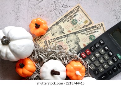 Dollar Money With Calculator And Halloween Pumpkin Decorating On Table