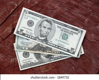Dollar notes against wooden background