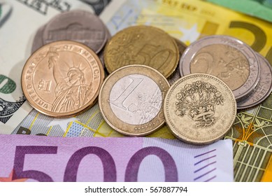 Dollar, Pound, Euro Coin On Euro Background.