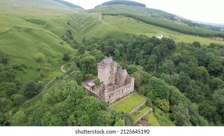 Dollar, Scotland; June 2021: Aerial image of Castle Campbell at the head of the heavily wooded Dollar Glen in the Ochil Hills, just above the town of Dollar in Central Scotland.