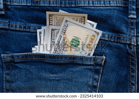 dollars bills lies in jeans pocket.money in wallet.savings.cash.international currency.
currency exchange.money theft.bribe.passive income.bank credit.banking system.save money.motivation.
100 dollars