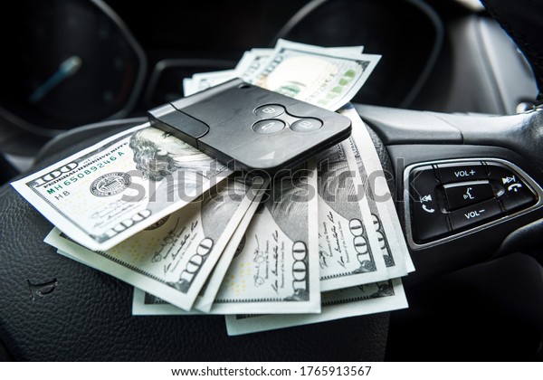 dollars with a car key lie in inside cars.\
financial concept