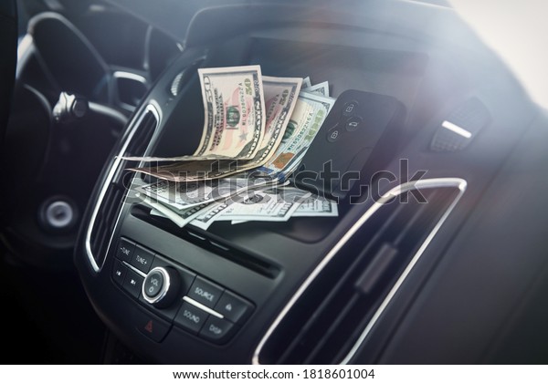 dollars with a car key lie in inside cars.\
financial concept