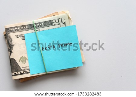 Dollars cash money and paper note with text written SIDE HUSTLE on copy space background - concept of financial planning - make more extra money from parttime side hustle or second job