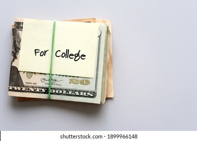 Dollars Cash Money In Rubber Band With Text Written Note  FOR COLLEGE , On Copy Space Background - Concept Of Financial Planning To Save Money For Purpose Of Education