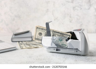 Dollars In Currency Counting Machine On Light Background