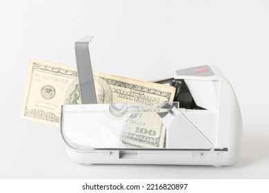 Dollars In Currency Counting Machine On Light Background