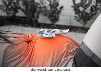 Dollars Lie On The Belly Of A Pregnant Woman (the Concept Of Surrogate Motherhood)