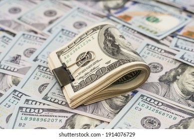 dollars with metal clip on dollars background.Much money. - Shutterstock ID 1914076729