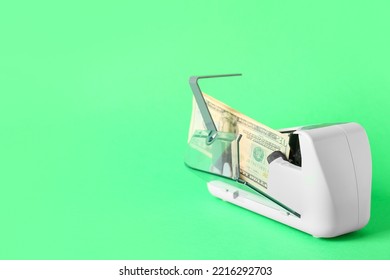 Dollars In Modern Currency Counting Machine On Green Background