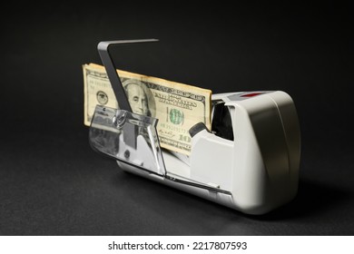 Dollars In Modern Currency Counting Machine On Dark Background