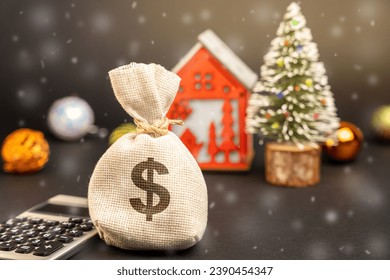 Dollars money bag on the background of a Christmas tree, house and snow. Accumulating money and planning a budget. Business and finance. Loans, deposit, credit. Promotions, offers. Xmas winter holiday