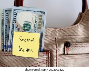 Dollars money in woman bag with sticky note SECOND INCOME ,concept of earn money from side hustle, side gig or part time job, side business to boost more income