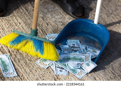 Dollars On The Ground Are Collected With A Brush In A Scoop. Dirty Money Fight Concept.