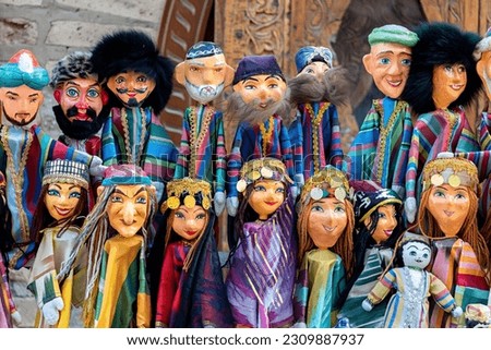 Dolls dressed in traditional uzbek costumes. Traditional souvenir puppet from painted mashed paper (papier mache). Itchan Kala (Xiva Ichon Qala). Khiva, Uzbekistan. Souvenir and gift concept