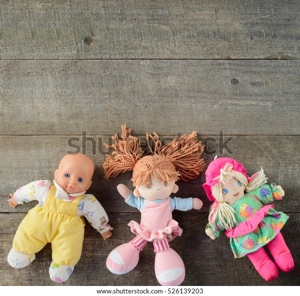 Dolls on\
wooden background. top view. copy\
space.