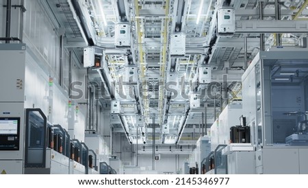 Dolly Shot Inside Bright Advanced Semiconductor Production Fab Cleanroom with Working Overhead Wafer Transfer System 