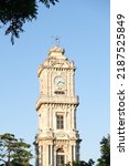 Dolmabahce Clock Tower with tree and blue sky. Selective focus area. Copy space area.