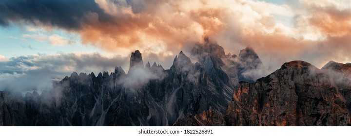Dolomites natural landcape in fog with mountain peak in North Italy