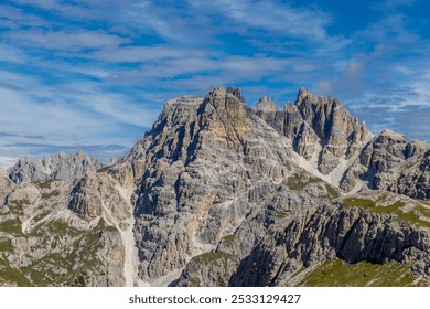 Dolomiti Alps mountain peaks in summer landscape on sunny weather beautiful day. Alpine scenery of the high rocky cliffs towering above green valleys in the Dolomites. Alpi Dolomiti summits blue sky - Powered by Shutterstock