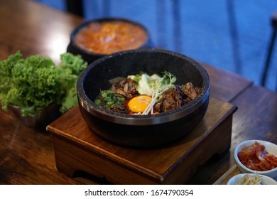 Dolsot bibimbap - Korean mixed rice, Include steamed rice, vegetables, pork and fried egg on top, served in a hot stone pot, Dolsot means stone pot in Korean.