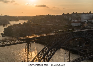 Dom Luís I Bridge, Porto, Portugal, Ponte De Dom Luís I, Spanning The Douro River, Designed By Gustave Eiffel. Golden Hour Orange Sunlight Landscape European Landmark  