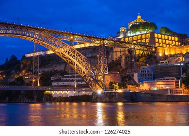 Dom Luis I bridge over Douro river and monastery of Serra do Pilar illuminated at night. Porto, Portugal
