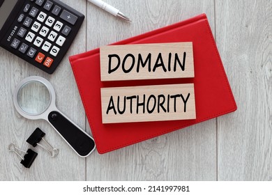 domain authority. text on wooden blocks on red notepad