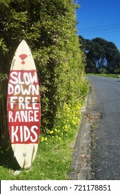 Domain Cres, Muriwai, Auckland, New Zealand - 13th September 2017: Surfboard On Side Of Road With 