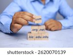 Domain name concept with businessman arrange wooden says to select .com to be a top level of domain in business website