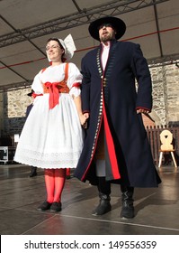 DOMAZLICE CZECH REPUBLIC - AUGUST 10: The Folklore Ensemble Usmev (Smile) dressed in traditional Czech (Pilsen) garb dancing and singing on The Chodske slavnosti medieval market on August 10, 2013. 