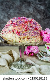 Dome Cake - Filled With Fruity Jelly, Dark Chocolate Mousse And Raspberry Puree, Covered With White Chocolate Ganache And Decorated With Colorful Sprinkles