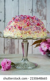 Dome Cake - Filled With Fruity Jelly, Dark Chocolate Mousse And Raspberry Puree, Covered With White Chocolate Ganache And Decorated With Colorful Sprinkles