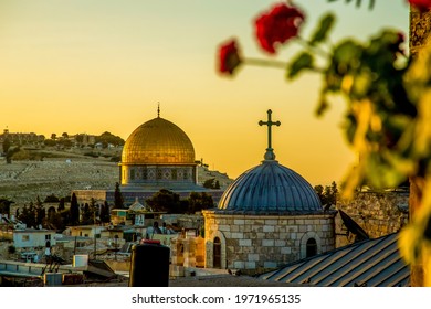 The dome of a Christian church and the dome of the rock in the setting sun