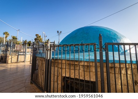 The dome painted blue above the building inside is the tomb of Rabbi Shimon Bar Yochai in Meron-Israel