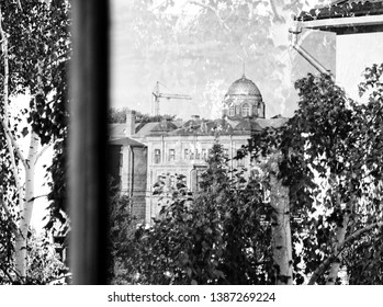 Dome reflected in opened window. Black and white.