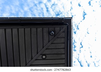 Dome security camera vigilantly watching residential property from building exterior
