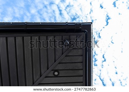 Dome security camera vigilantly watching residential property from building exterior