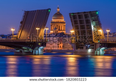 The dome of St. Isaac Cathedral in the alignment of the divorced Annunciation bridge on a white night. Saint Petersburg, Russia