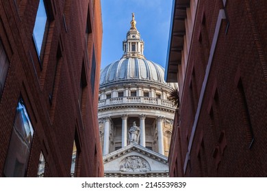 Dome Of The St Paul Cathedral Is Under Blue Sky Between Red Walls Of Old Houses. London, United Kingdom